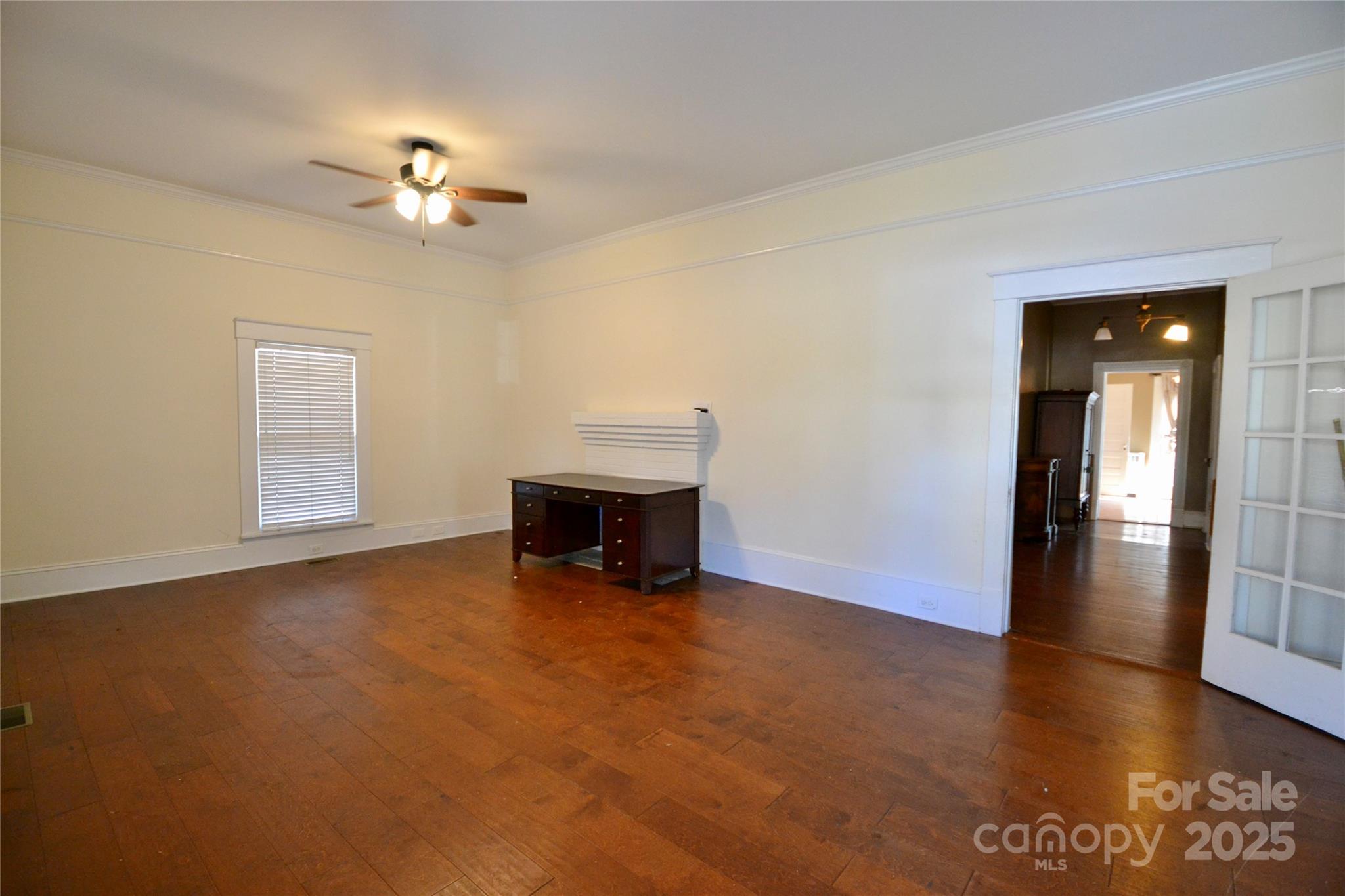 512 2nd Street Spencer, NC 28159 - Photo 10 of 33 an empty room with chandelier fan and windows