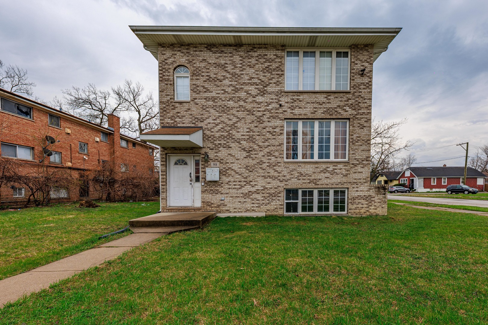98 West 154th Street Harvey, IL 60426 - Photo 1 of 8 a front view of a house with a yard
