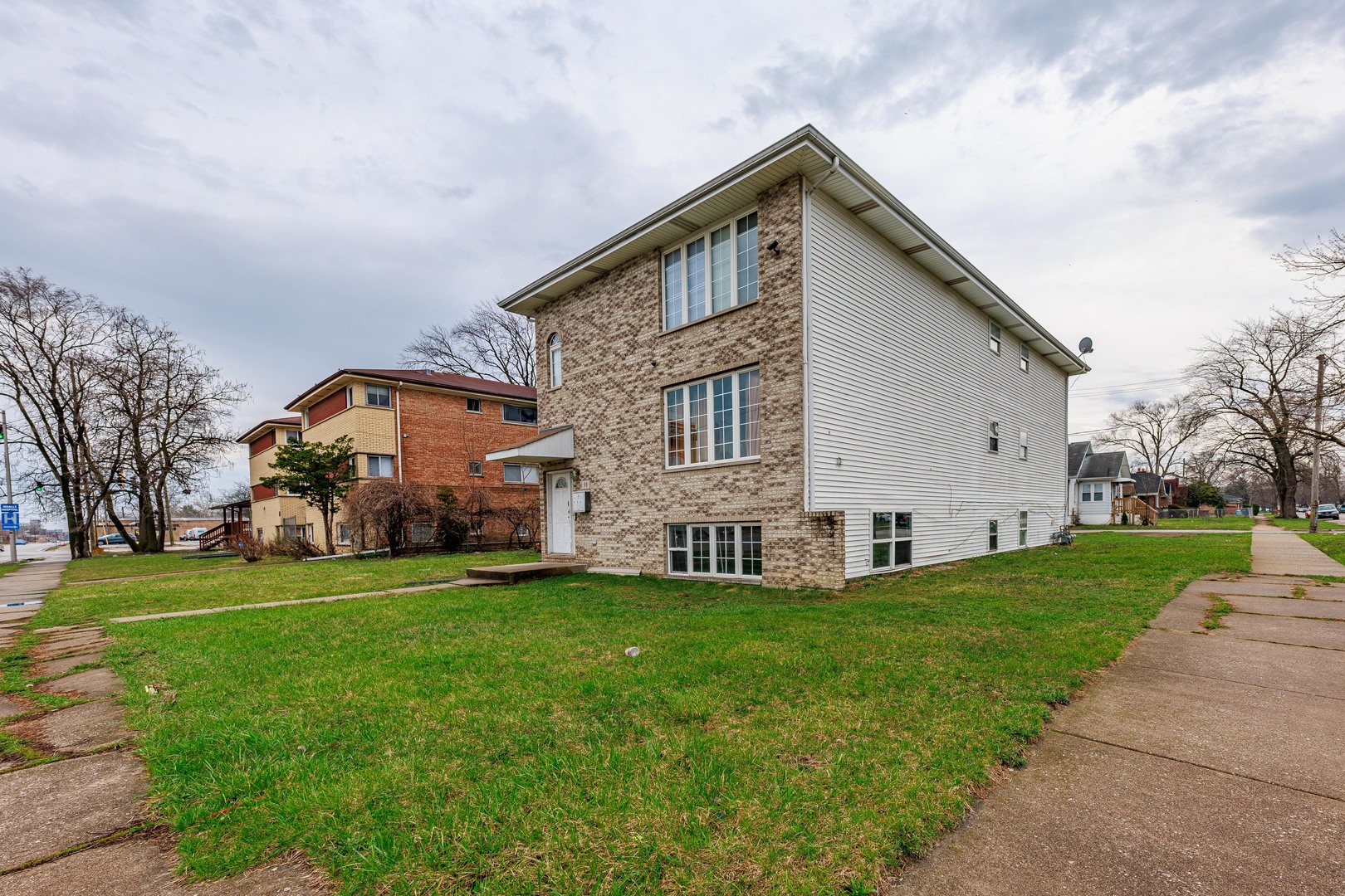 98 West 154th Street Harvey, IL 60426 - Photo 2 of 8 a view of a house with a yard
