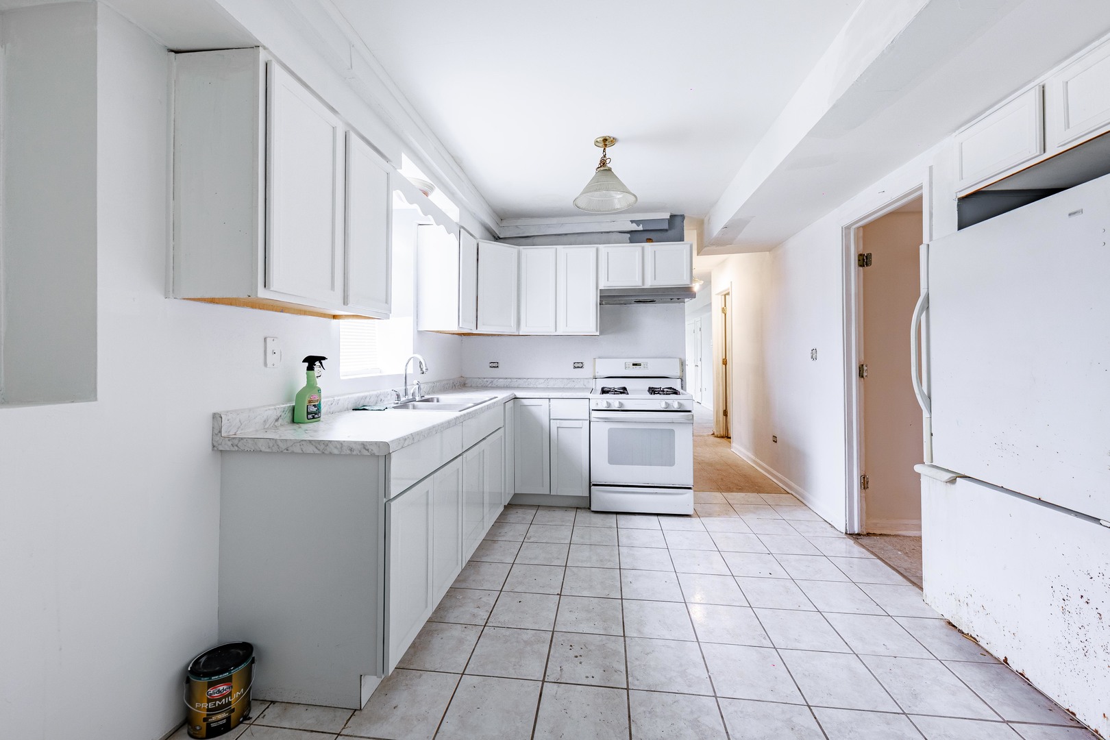 98 West 154th Street Harvey, IL 60426 - Photo 4 of 8 a kitchen with a sink a refrigerator and cabinets