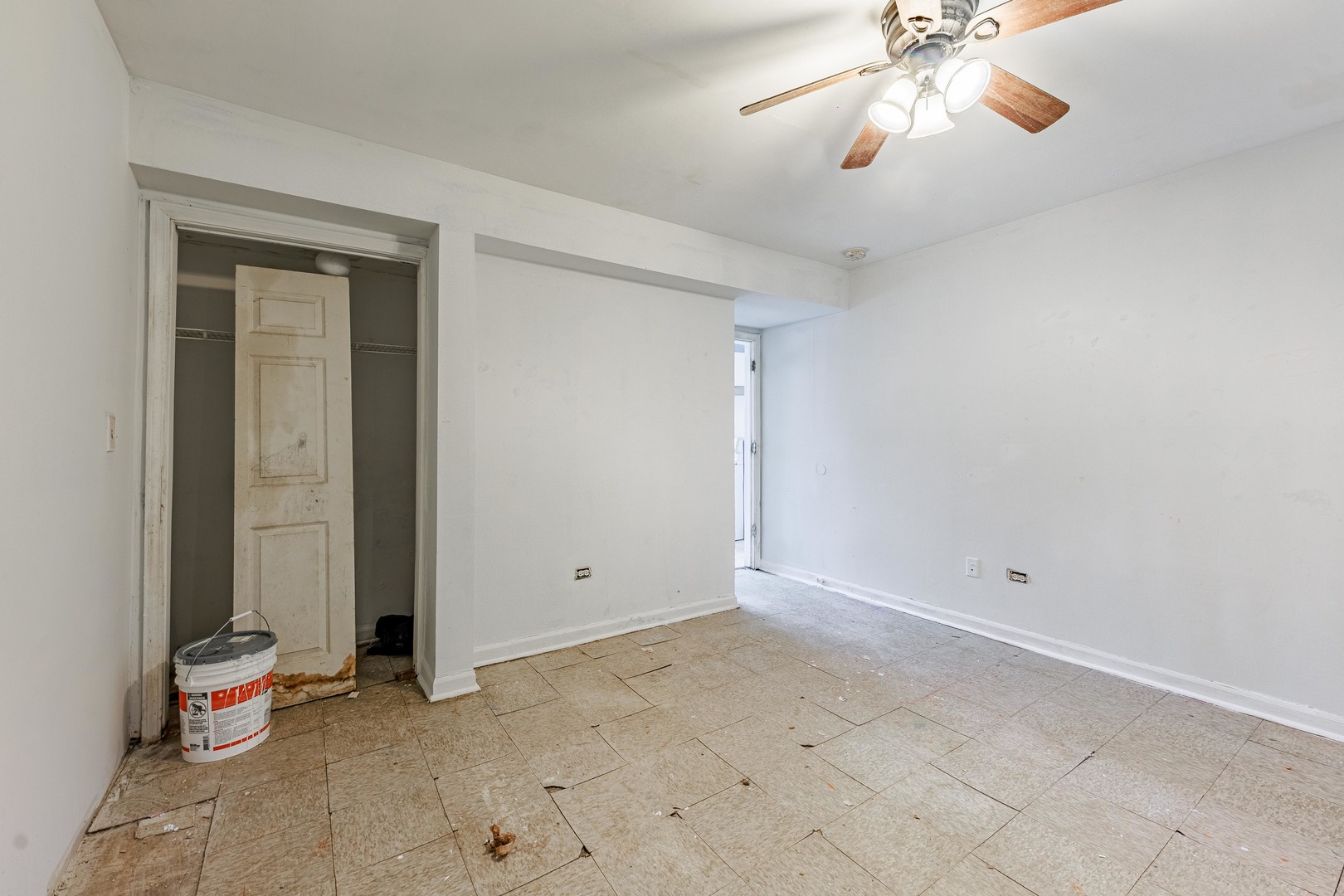 98 West 154th Street Harvey, IL 60426 - Photo 6 of 8 an empty room with closet and a chandelier fan