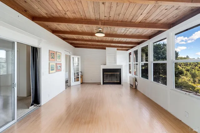 a view of an empty room with a fireplace