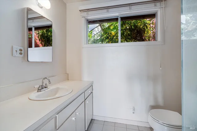 a bathroom with a sink toilet and a mirror
