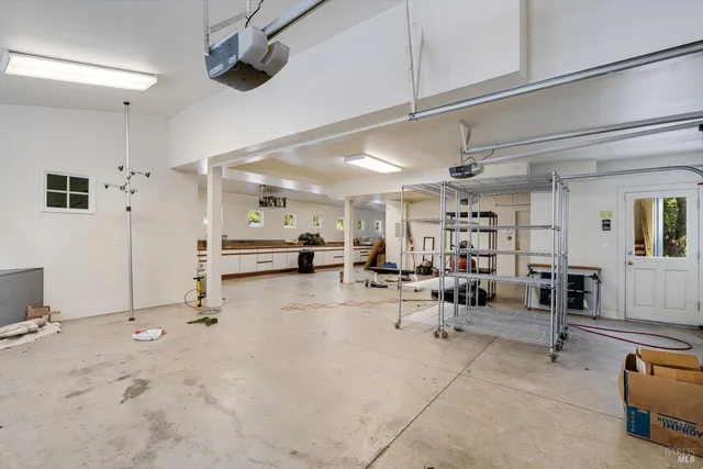 a spacious bedroom with a bed and glass windows