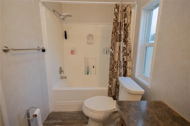 a kitchen with stainless steel appliances granite countertop a stove refrigerator and cabinets