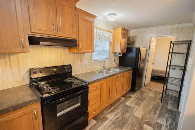 a kitchen with granite countertop a stove and a refrigerator