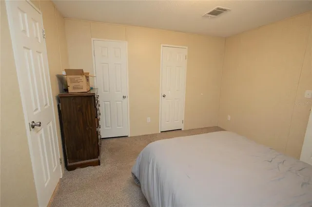 a bedroom with a bed and a mirror