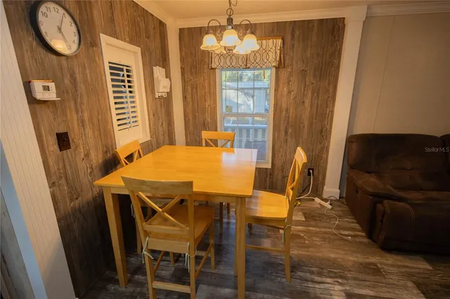 a view of a workspace with furniture and wooden floor