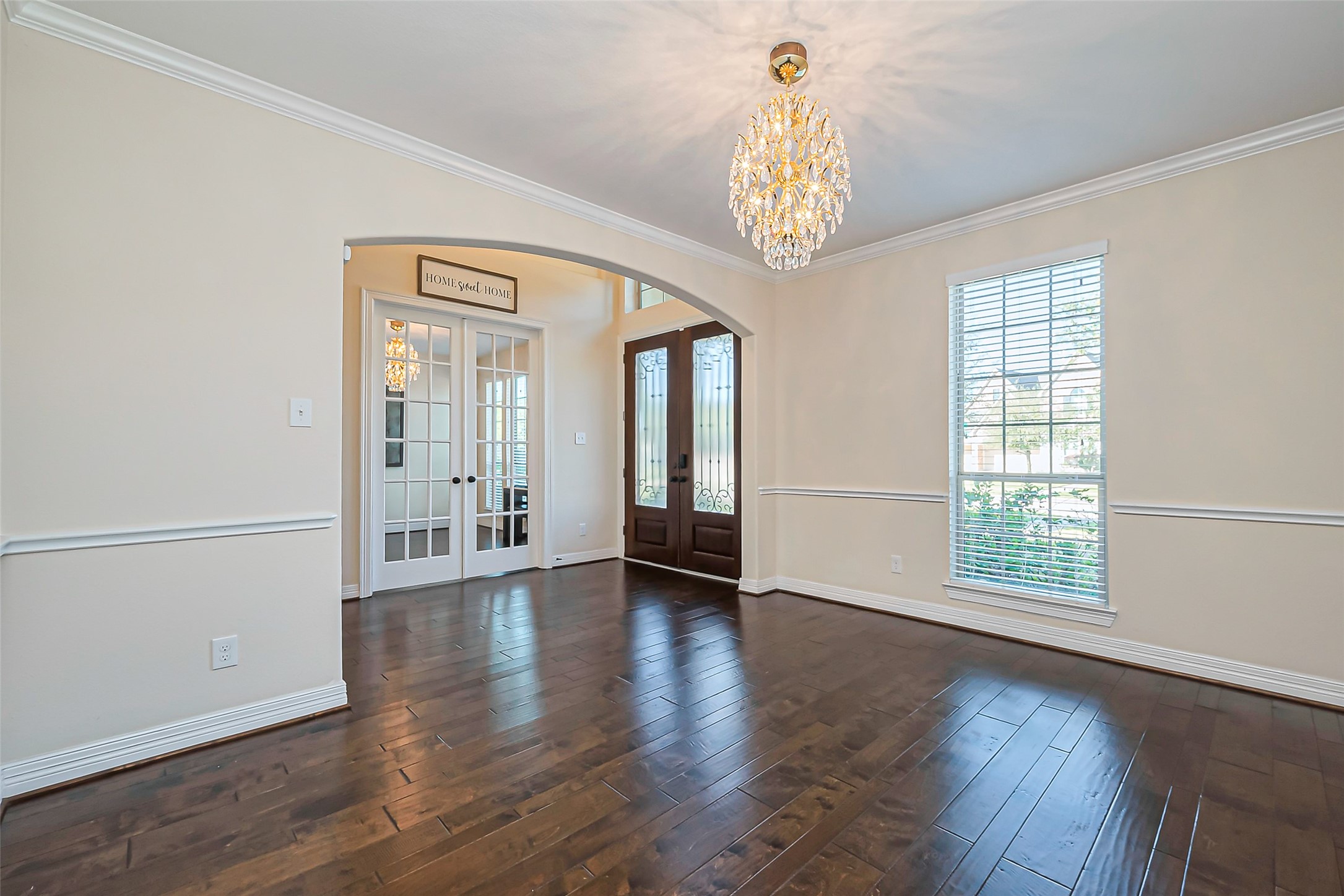 10018 Durango Path Lane Cypress, TX 77433 - Photo 11 of 50 Elegant dining room featuring abundant natural light, and a stunning chandelier, perfect for entertaining and enjoying exquisite dinners with the family.