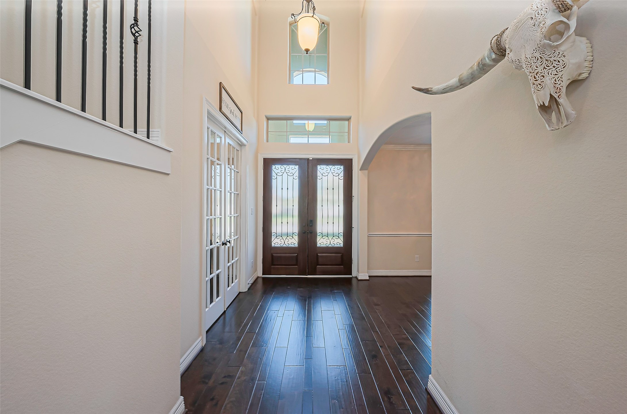 10018 Durango Path Lane Cypress, TX 77433 - Photo 8 of 50 Welcome guests in style with this elegant foyer, featuring high ceilings, rich wood floors, and abundant natural light.
