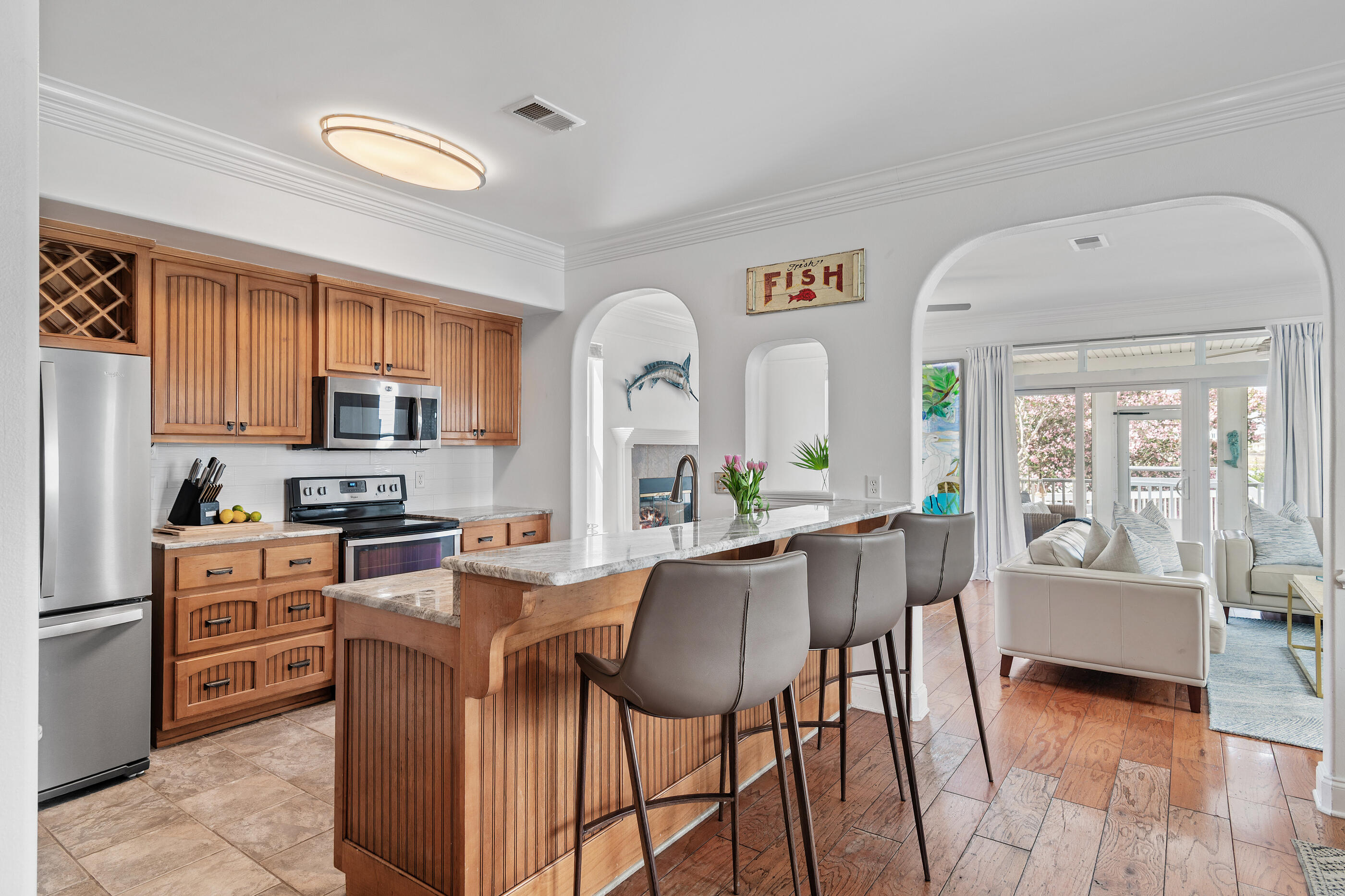34 Beachside Drive Santa Rosa Beach, FL 32459 - Photo 19 of 65 a living room with stainless steel appliances granite countertop furniture a stove a kitchen island with large windows and wooden floor