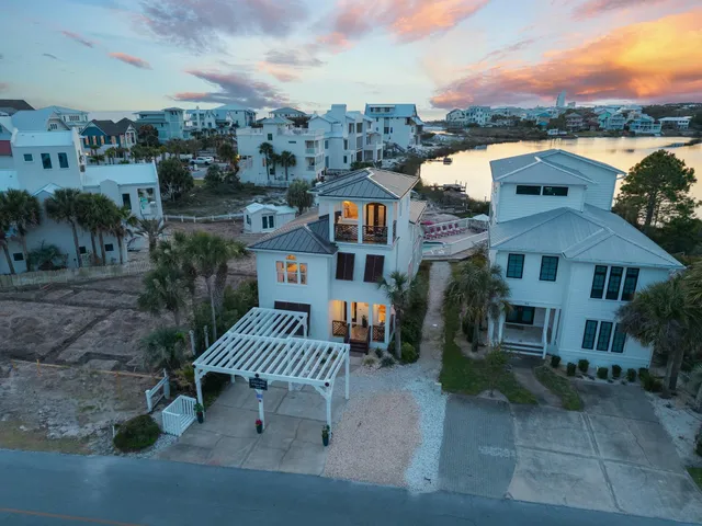an aerial view of a house with a yard and balcony