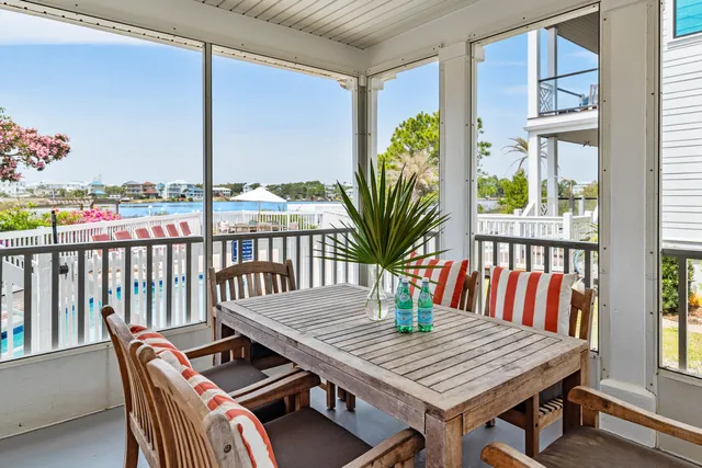a balcony with furniture and umbrella