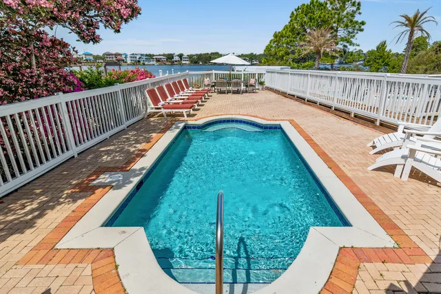 a view of a balcony with two chairs and a potted plant