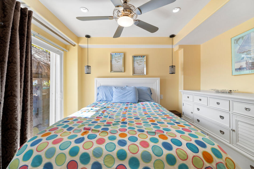 23 South Exuma Road Key Largo, FL 33037 - Photo 17 of 24 a bedroom with a bed and a chandelier