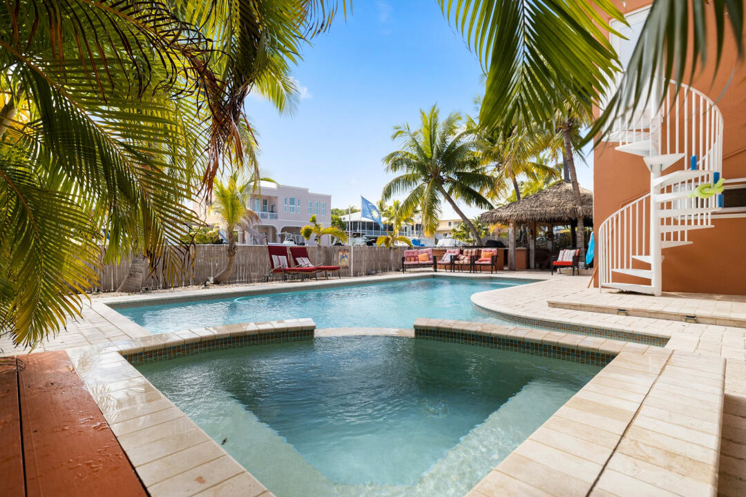23 South Exuma Road Key Largo, FL 33037 - Photo 3 of 24 a view of a swimming pool with chairs