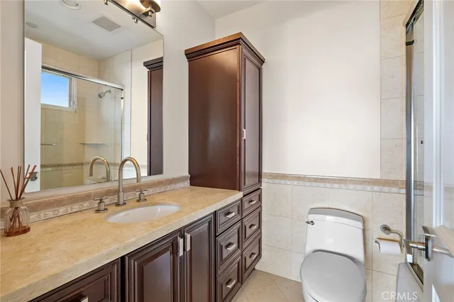 a spacious bedroom with a bed couch and a window