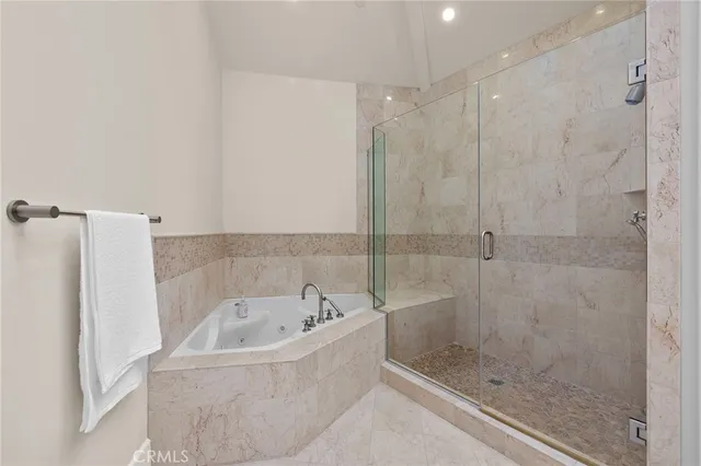 a spacious bathroom with a shower sink and mirror