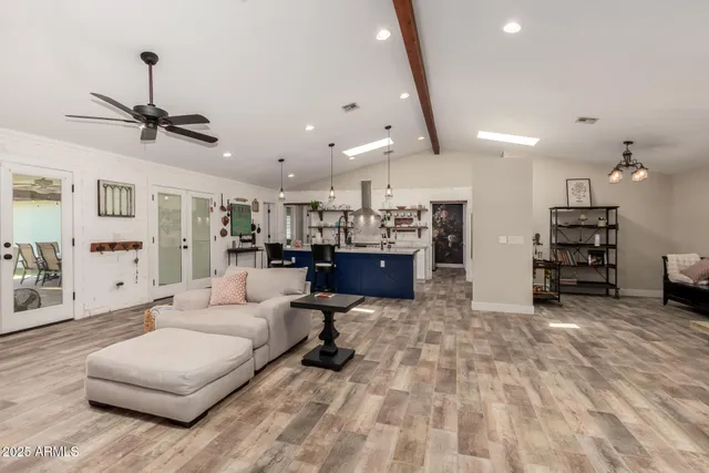 a living room with lots of furniture and kitchen view