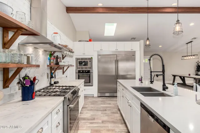 a kitchen with stainless steel appliances a refrigerator and a stove