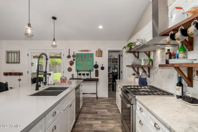 a kitchen with appliances a sink and cabinets