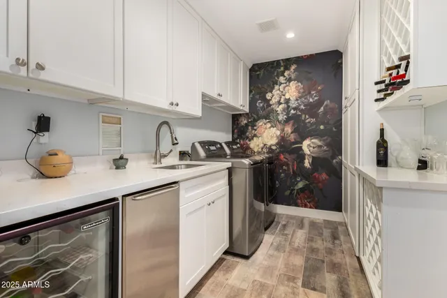 a spacious bedroom with a bed and a chandelier