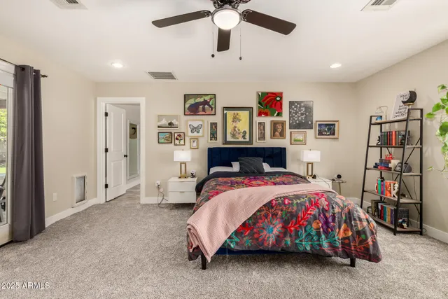 a bathroom with a granite countertop sink mirror and a toilet