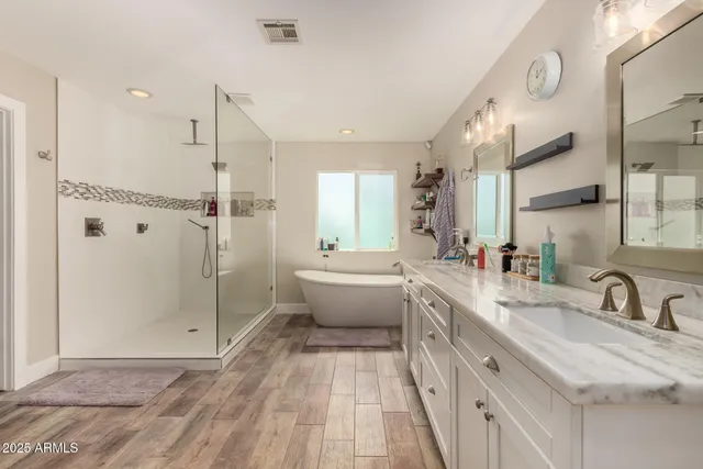 a view of walk in closet with clothes