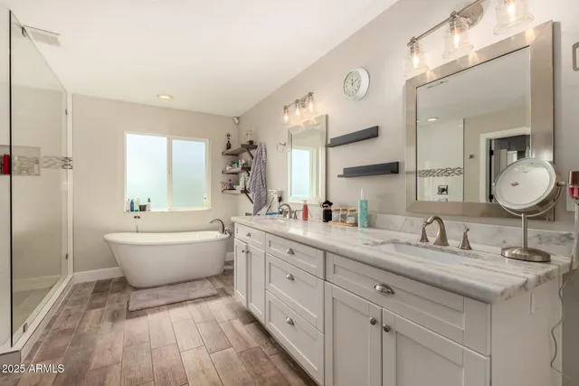 a bedroom with a large bed and a chandelier