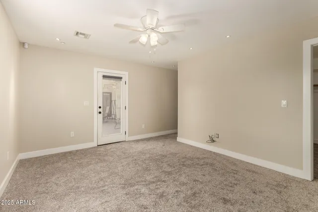 a view of a backyard with plants and a patio
