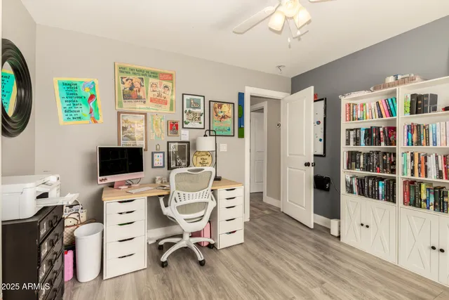 a view of a house with a yard and a large tree
