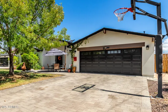 a view of a patio with a table and chairs under an umbrella