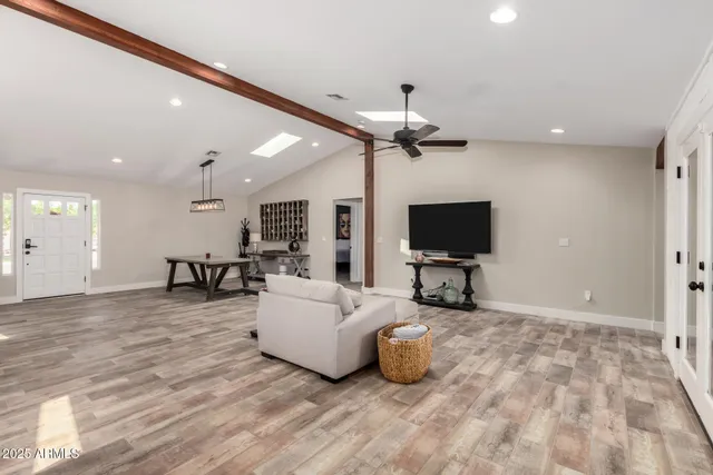 a large living room with stainless steel appliances kitchen island granite countertop furniture and a view of kitchen