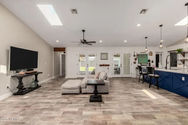 a living room with furniture and kitchen view