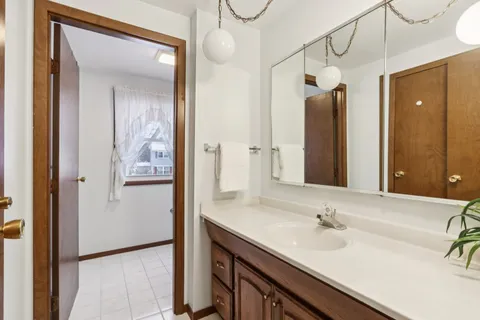 a bathroom with a double vanity sink mirror and