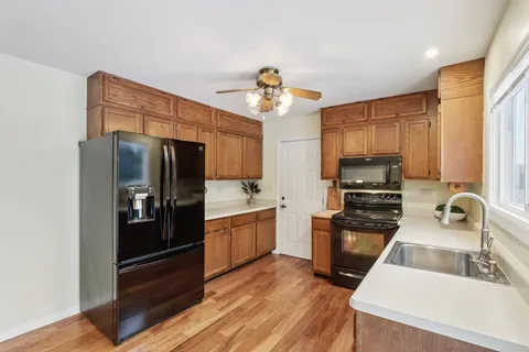 a kitchen with stainless steel appliances a refrigerator stove and sink