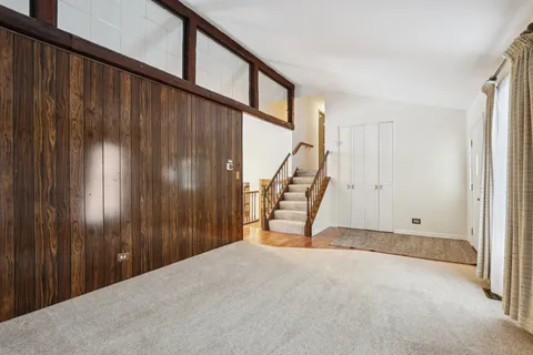 a view of an empty room with stairs
