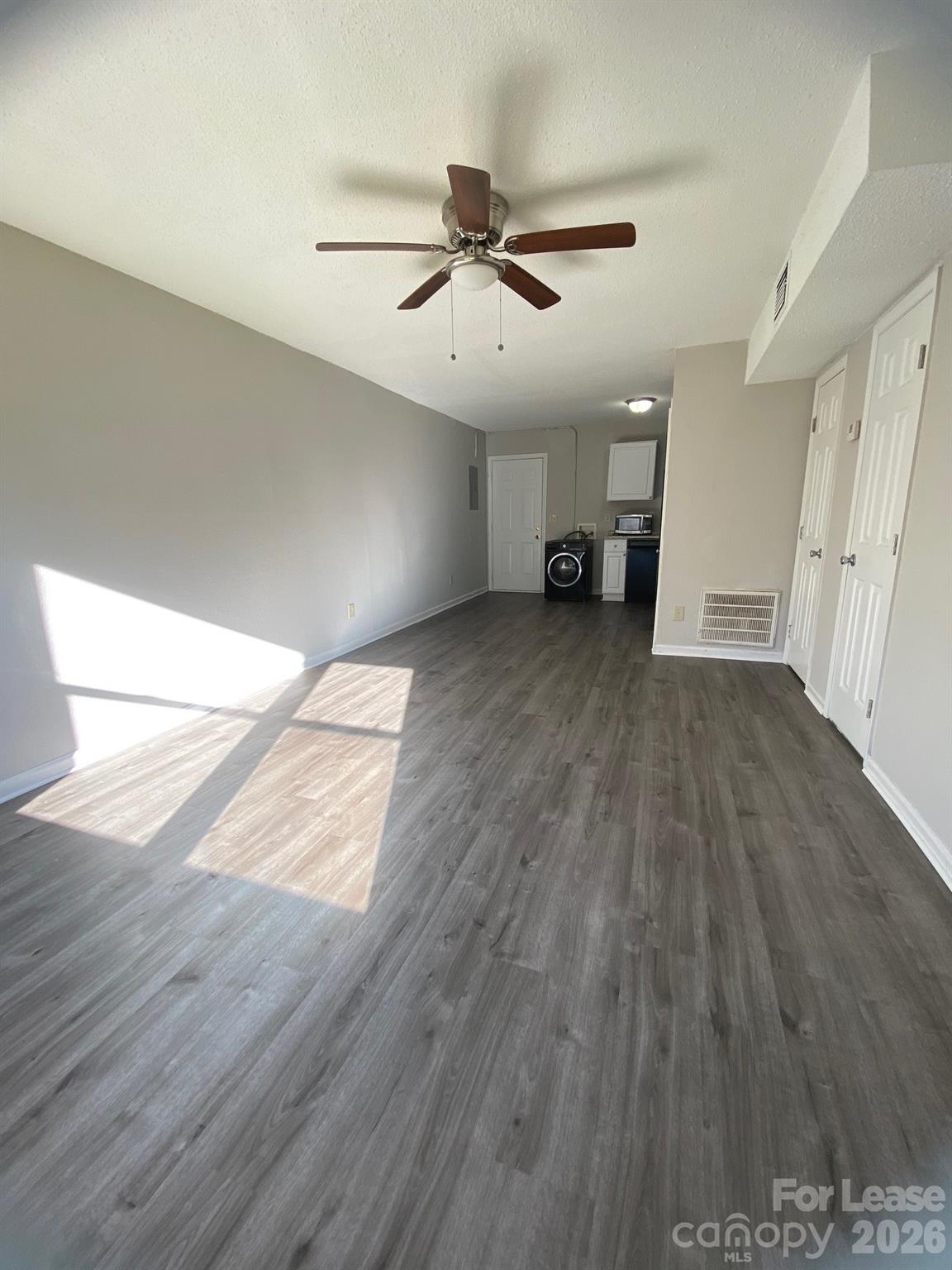 900 Junius Street, Unit A Gastonia, NC 28052 - Photo 2 of 10 wooden floor in an empty room with a window
