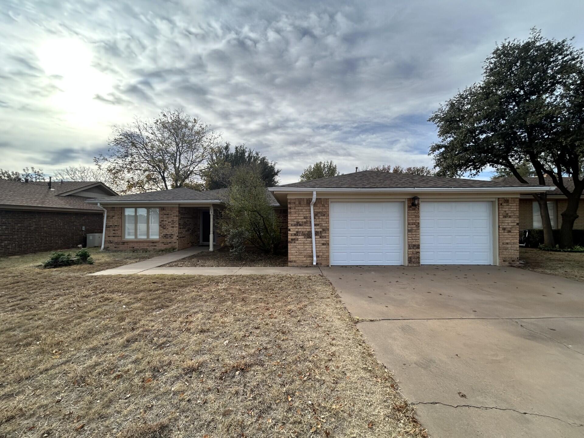 5517 89th Street Lubbock, TX 79424 - Photo 1 of 20 front view of a house with a stove and a fireplace