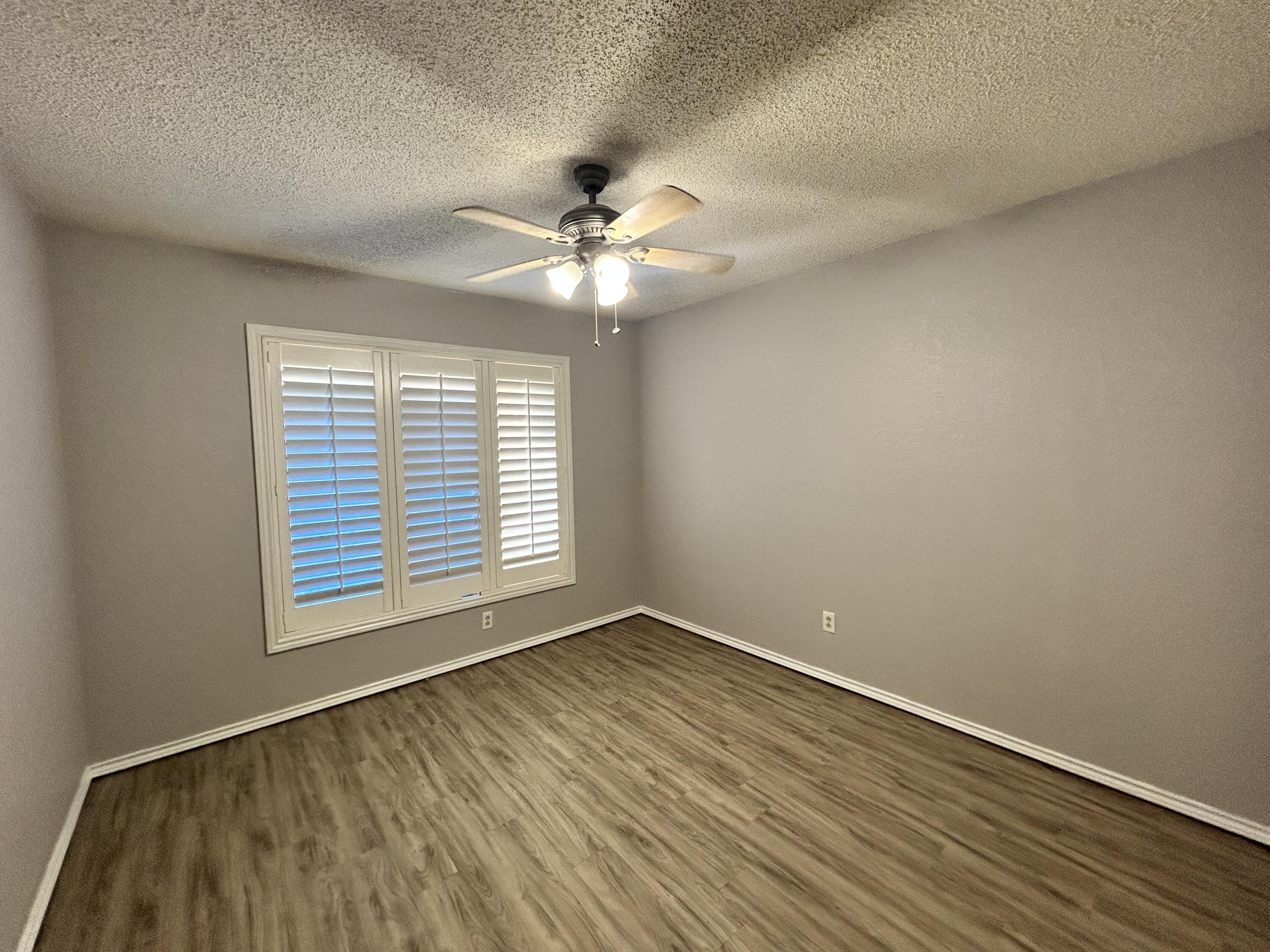 5517 89th Street Lubbock, TX 79424 - Photo 14 of 20 wooden floor in an empty room with a window
