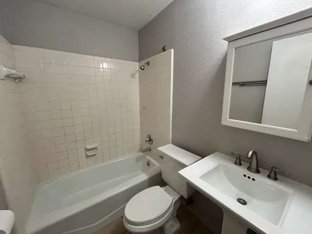 a bathroom with a sink toilet and shower
