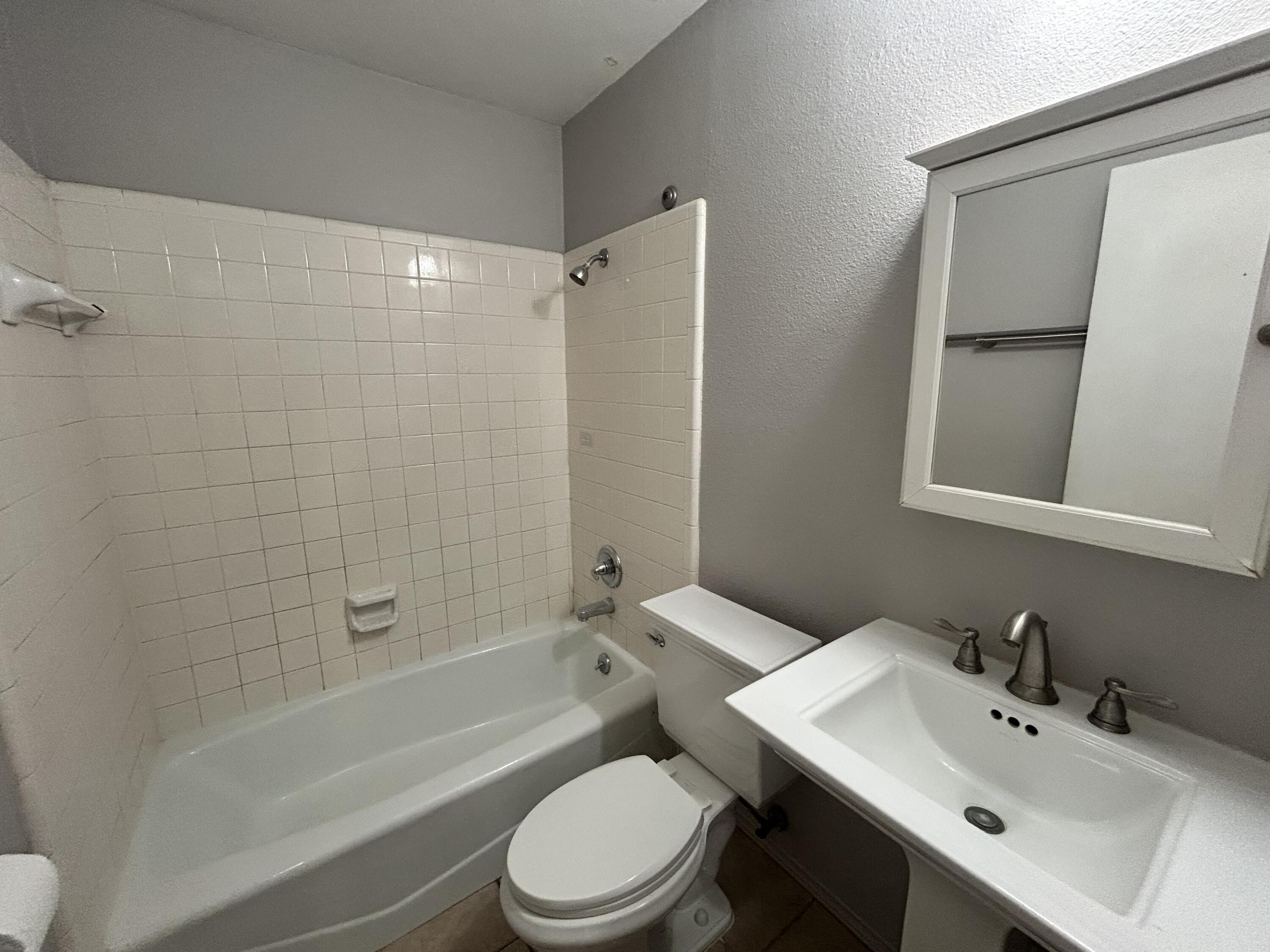 5517 89th Street Lubbock, TX 79424 - Photo 15 of 20 a bathroom with a sink toilet and shower