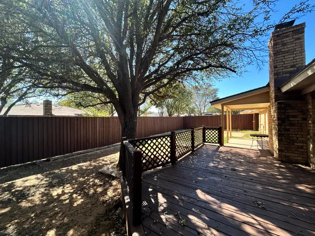 a view of a wooden bench with a bench in a patio