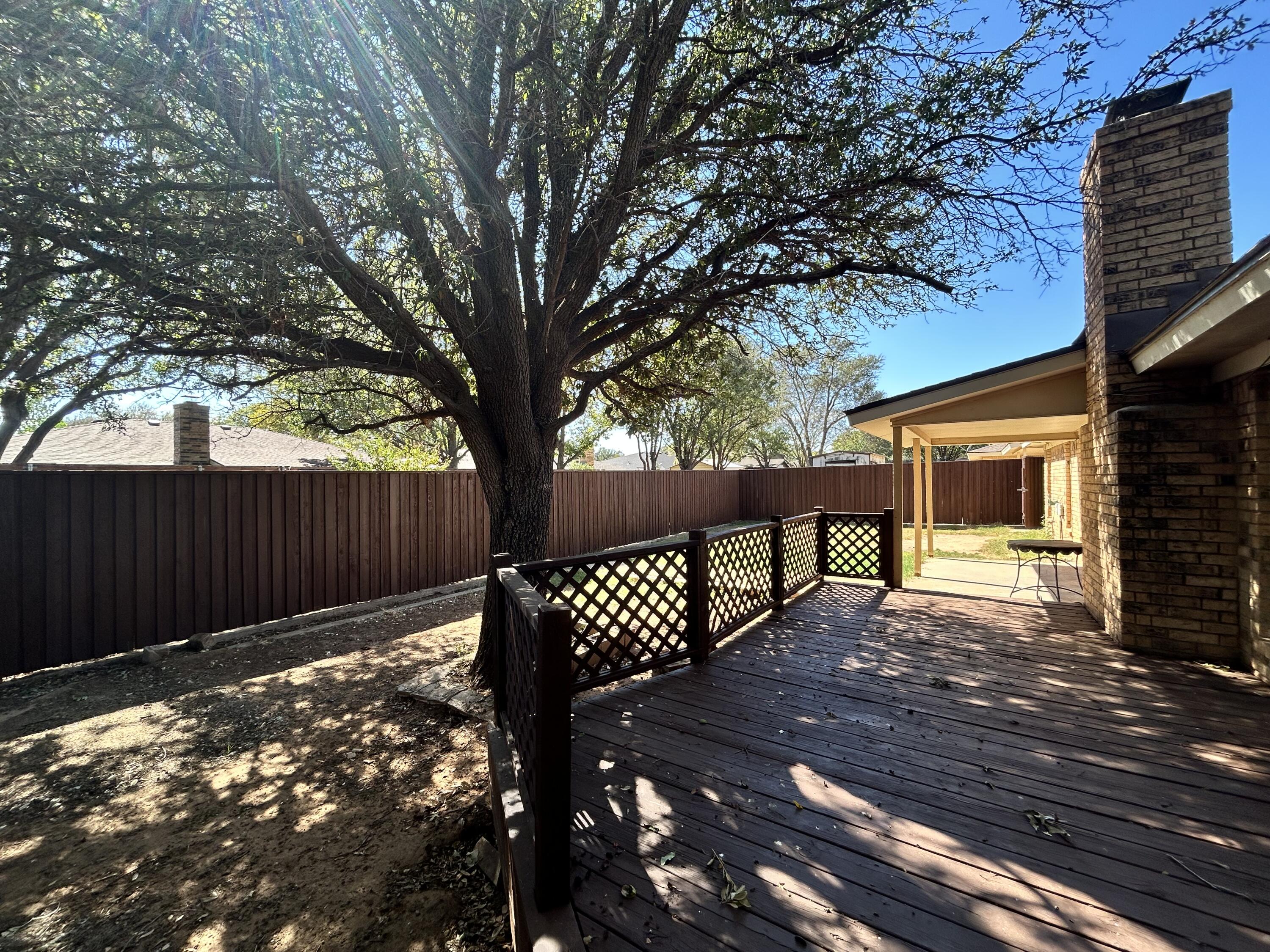 5517 89th Street Lubbock, TX 79424 - Photo 17 of 20 a view of a wooden bench with a bench in a patio