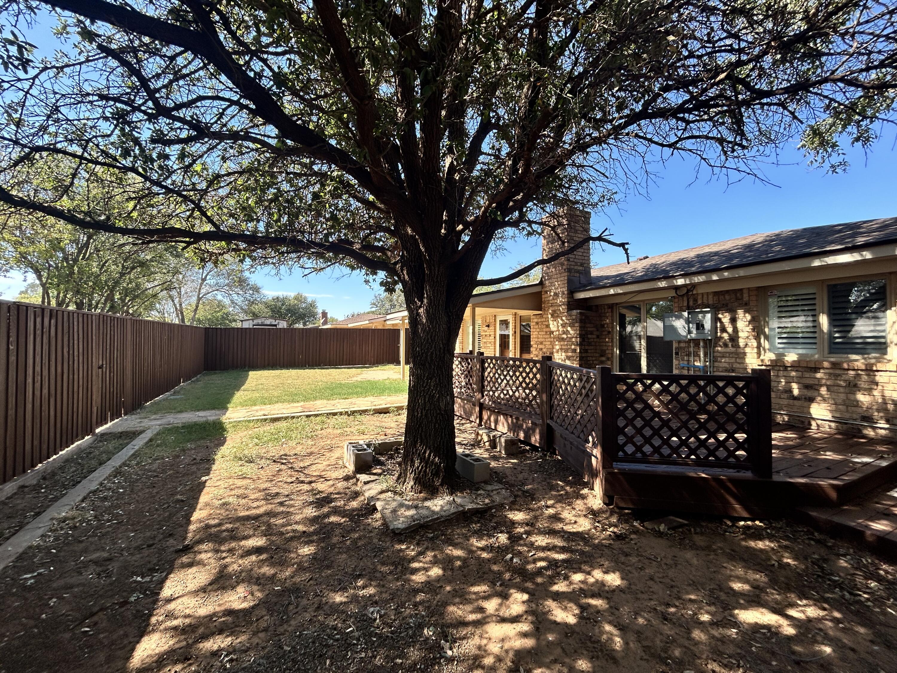 5517 89th Street Lubbock, TX 79424 - Photo 18 of 20 a view of a yard with wooden fence