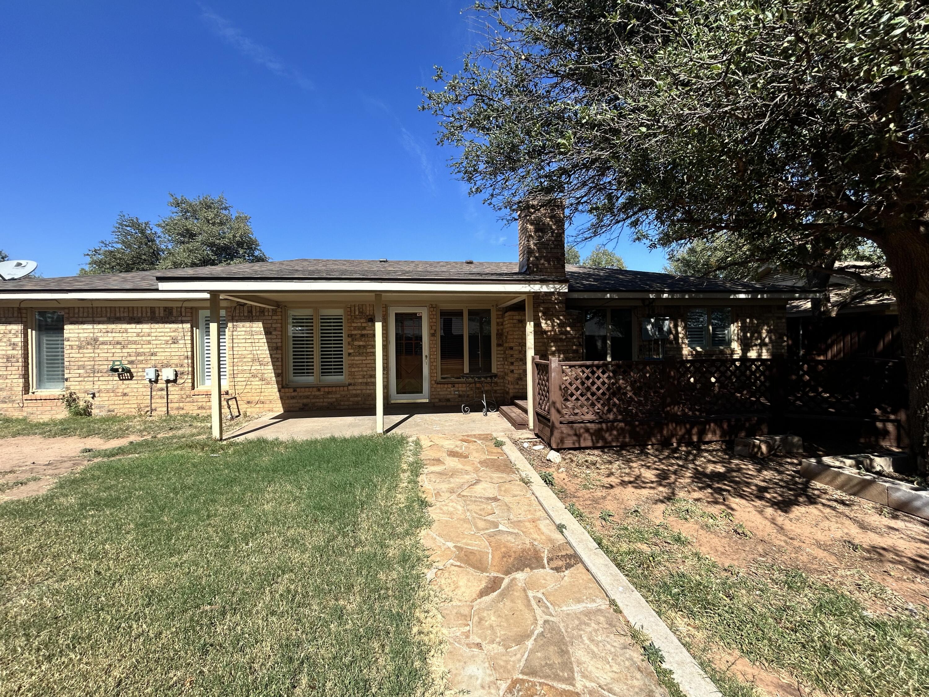 5517 89th Street Lubbock, TX 79424 - Photo 19 of 20 a front view of a house with a yard and garage