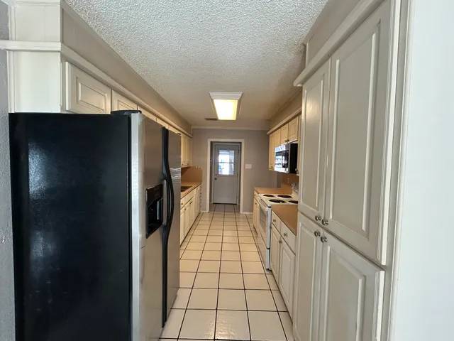 a view of a hallway view with wooden floor and staircase