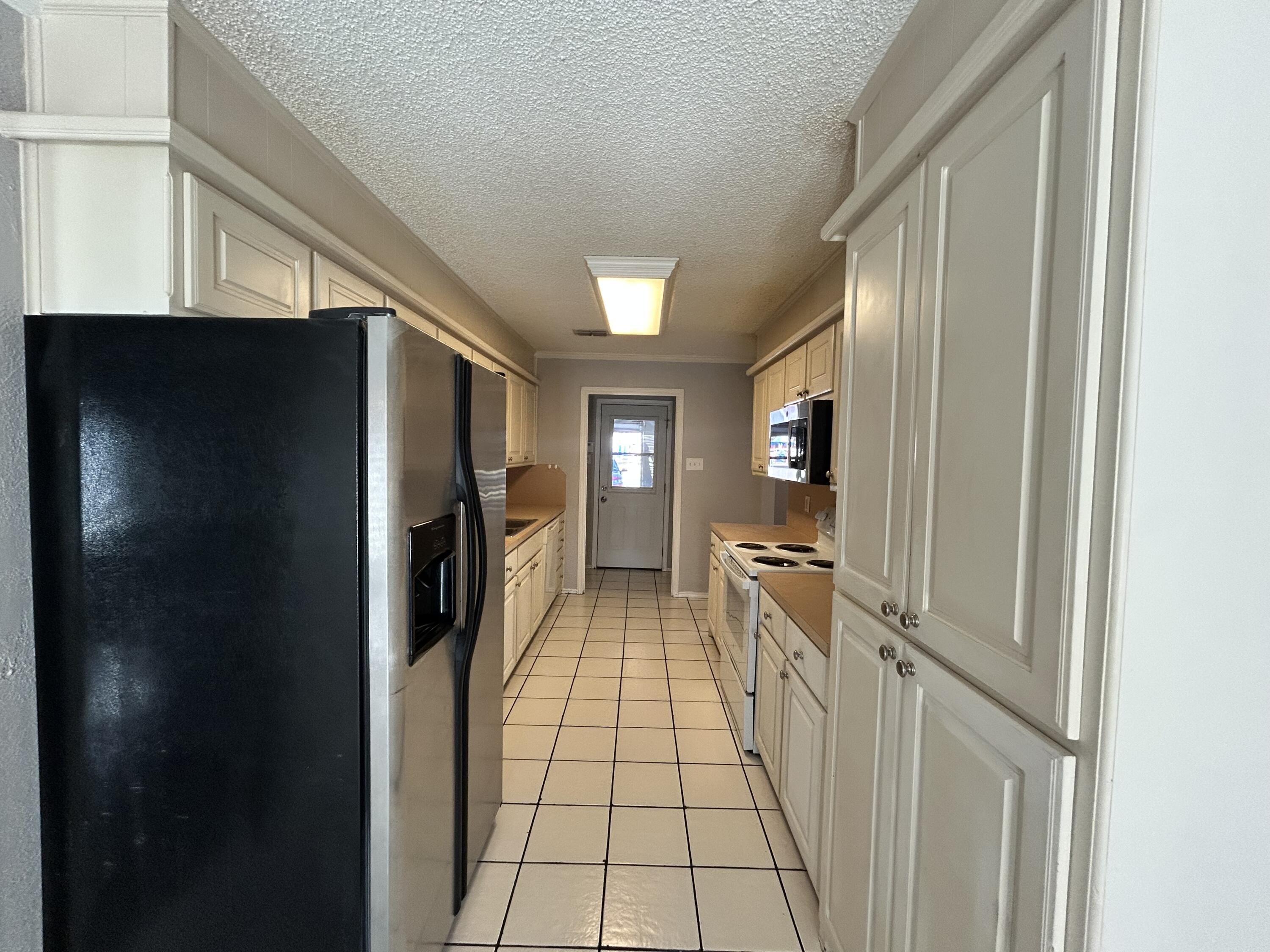 5517 89th Street Lubbock, TX 79424 - Photo 7 of 20 a view of a hallway view with wooden floor and staircase