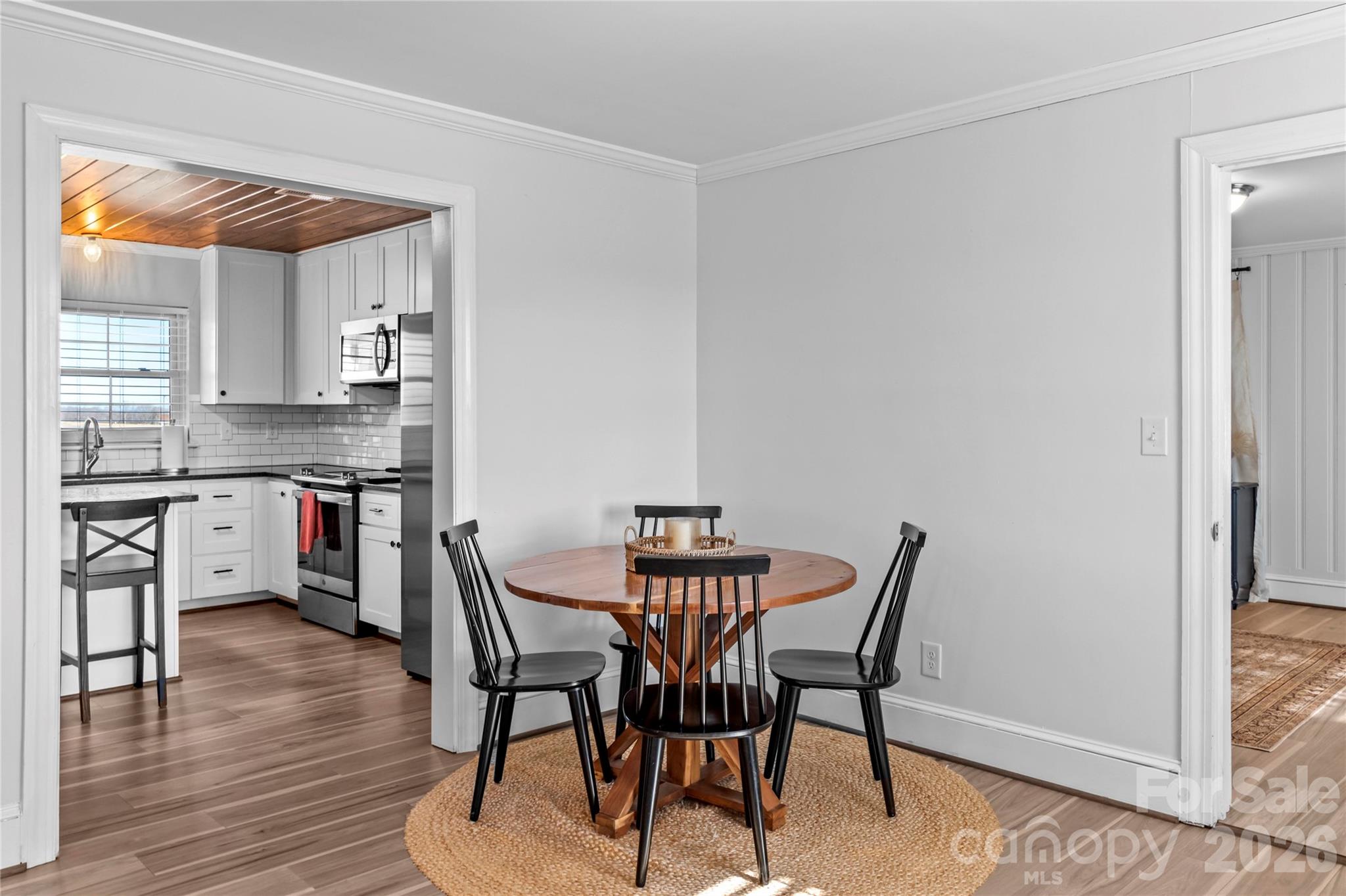 2432 Holcomb Road Yadkinville, NC 27055 - Photo 12 of 37 a view of a dining room with furniture and wooden floor