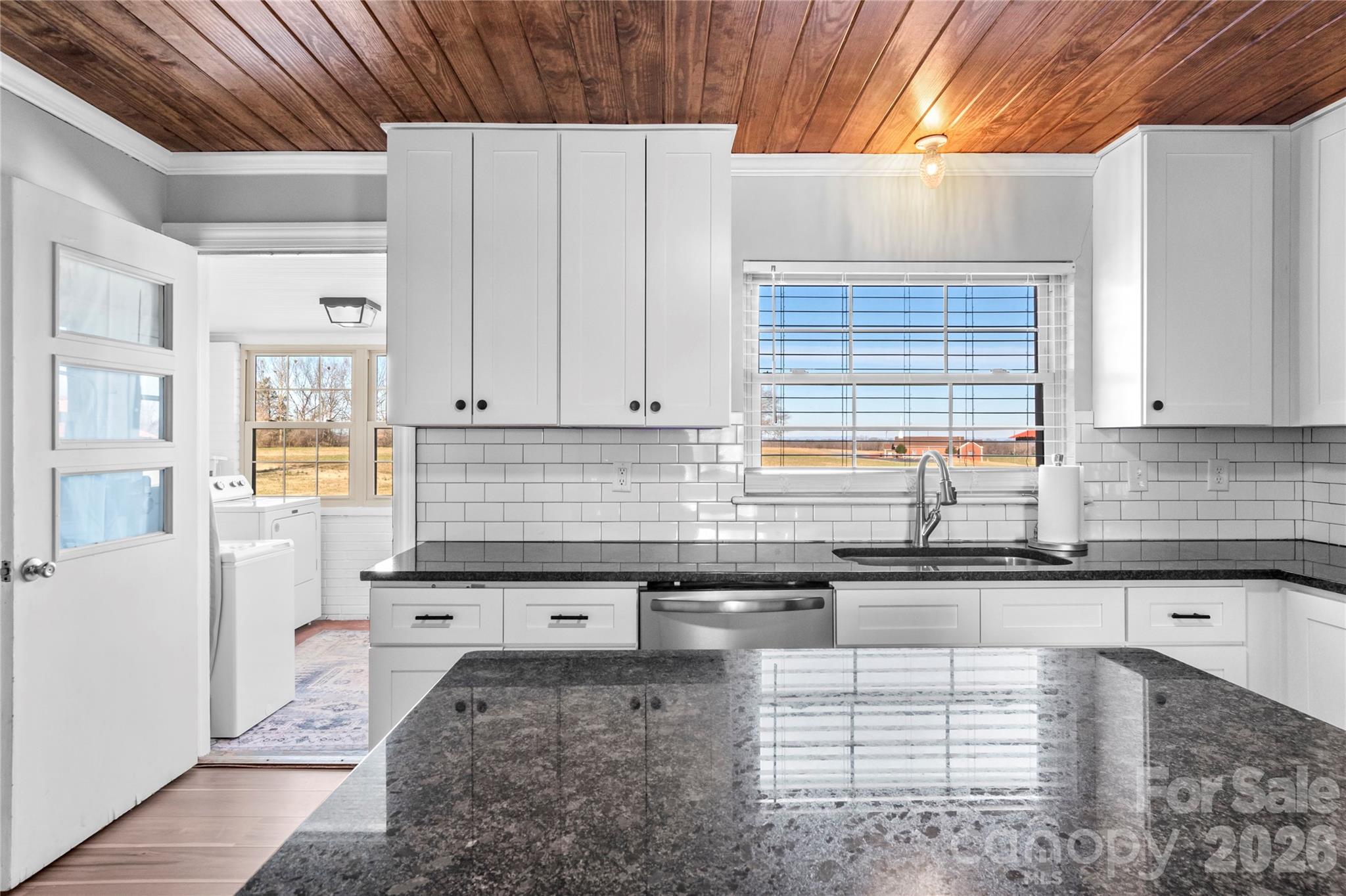 2432 Holcomb Road Yadkinville, NC 27055 - Photo 16 of 37 a kitchen with granite countertop a sink a counter top space and cabinets